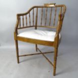 A mid-century Baker style faux bamboo tub chair
