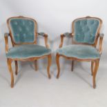 A pair of Continental walnut and upholstered open-arm armchairs
