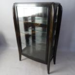 An Austrian Art Deco ebonised display cabinet, with bevelled glass, circa 1925, 90 x 147 x 38cm