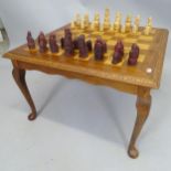 A reproduction teak games-top coffee table, on cabriole legs, 65 x 41 x 65cm