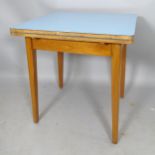 A mid-century formica-topped draw leaf kitchen table, on teak base, label for PHG & Sons, Guildform,