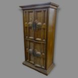 A Spanish oak 4-door armoire, the interior fitted with 4 drawers and shelved compartments, 99cm x