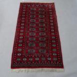 A red ground Tekke design rug, 168cm x 94cm