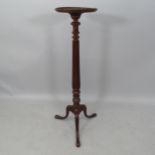 A reproduction mahogany torchere, with carved fluted column on tripod base, H110cm
