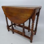 An Antique oak oval gateleg drop leaf table, 86cm x 74cm x 38cm