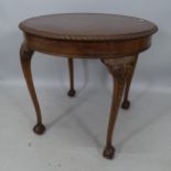 A reproduction mahogany circular-top occasional table, with carved decoration, raised on cabriole