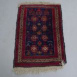 A small red ground Afghan design rug, 118 x 82cm