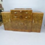 An Art Deco burr-walnut veneered sideboard, having raised centre section, 2 fitted drawers and