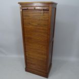 An early 20th century oak tambour-front filing cabinet, 54cm x 141cm x 38cm (with key)