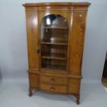 A 1930s walnut bow-front display cabinet, with single-glazed door and 2 drawers and cupboards under,