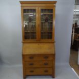 An Art Nouveau style oak 2-section bureau bookcase with top section having 2 leadlight glazed doors