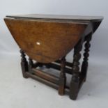 An Antique oak oval gateleg drop leaf table, 74cm x 62cm x 42cm