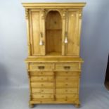 An Antique pine 2-section cabinet on chest, the upper section having 2 panelled doors, the lower