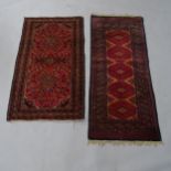 2 red ground Persian rugs, 143 x 60cm, and 124 x 72cm