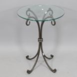 A circular glass-top occasional table, on wrought-iron base, 35cm x 62cm