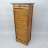 An early 20th century oak tambour-front filing cabinet, 52cm x 125cm x 38cm
