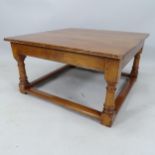 A contemporary mahogany square-top coffee table, on turned legs with all-round stretcher, 92cm x