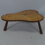 A mid-century oak low coffee table of shaped form, with carved rose decoration, 75 x 33 x 50cm