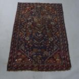 A red ground Baluchi rug, 150 x 107cm Areas of heavy wear with loss of pile, some moth damage and