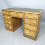 A Victorian pine kneehole writing desk, with tooled embossed green leather skiver and 9 fitted