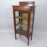 An Edwardian mahogany and satinwood-inlaid display cabinet, with raised back and single glazed and