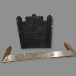 A 19th century cast-iron fire-back with embossed decoration, and an Arts and Crafts copper-clad