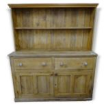 An Antique pine Irish style dresser in 1 section, with raised back, 2 fitted drawers and cupboards