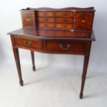 A reproduction mahogany bow-front lady's writing desk, with raised drawer-fitted back, tooled and