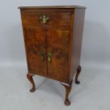A 1920s walnut bedside cabinet, with drawer and cupboards, 38 x 69 x 32cm