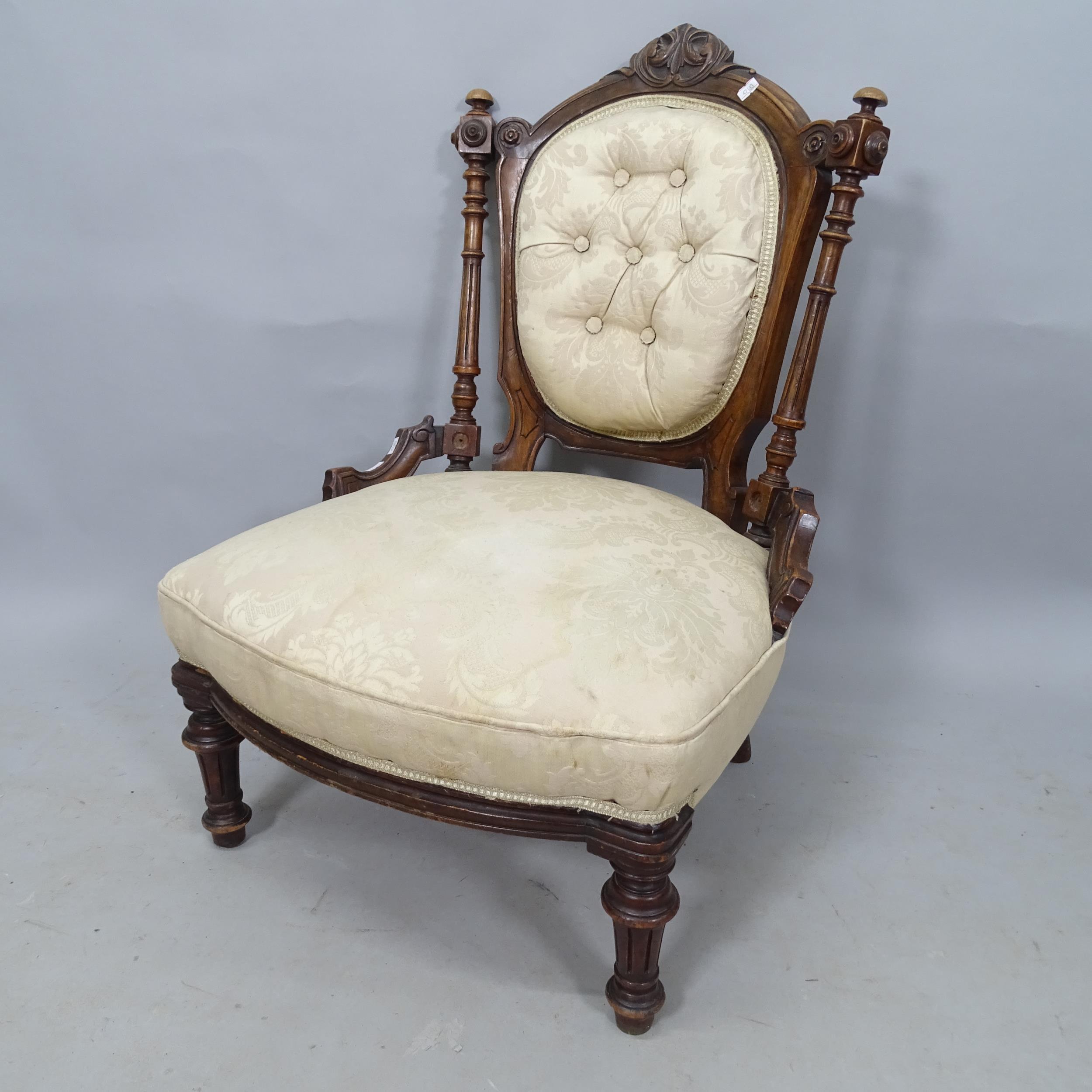 A 19th century mahogany and button-back upholstered nursing chair, with carved decoration