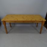 A contemporary pine dining table, on turned legs, 182 x 76 x 80cm