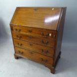 A Georgian cross-banded mahogany bureau, with well fitted interior, 4 long drawers beneath on