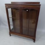 A 1930s mahogany display cabinet, with 2 glazed panelled doors, raised back, on cabriole legs, 93