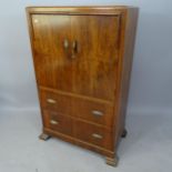 A 1930s mahogany tallboy, with 2 cupboard doors and 2 drawers under, 78 x 123 x 45cm