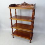 A reproduction mahogany 4-tier whatnot, with raised back on turned columns, 69 x 111 x 35cm