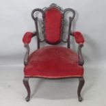 An Antique ebonised and upholstered open armchair, with carved decoration