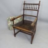 An Antique oak open armchair, with bobbin turned back and carved decoration