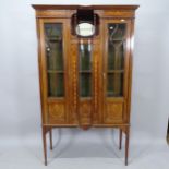 An Edwardian mahogany and satinwood-inlaid display cabinet, having 2 glazed panelled doors, with