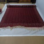 A large red ground Tekke design carpet, 375 x 210cm