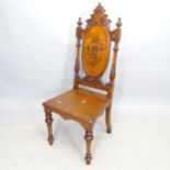 A 19th century mahogany hall chair, with applied carved decoration