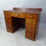 A 1930s mahogany kneehole writing desk, with raised back and 9 fitted drawers, 109cm x 88cm x 55cm
