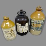 2 stoneware flagons, largest 35cm, label for Jacksons Light Varnish, and a glass demijohn ()