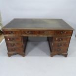 An Edwardian mahogany twin-pedestal writing desk, with inset tooled leather skiver and 9 fitted