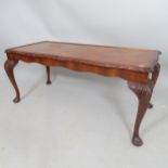 A reproduction mahogany burr-walnut low coffee table, with carved decoration, on cabriole legs,