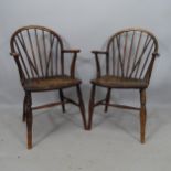 A pair of elm-seated stick-back elbow chairs