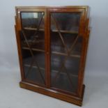 An Art Deco mahogany 2-door bookcase, with glazed panelled doors and 3 adjustable shelves, 94 x