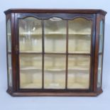 An Antique mahogany hanging display cabinet of canted form, with single lattice-glazed door and 3