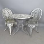 A circular wrought-metal garden table, 68 x 65cm, and 2 matching chairs