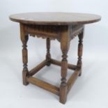 An Ipswich oak design circular-top occasional table, with carved decoration and all-round stretcher,