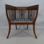 An Arts and Crafts square-back tub armchair, with stylised clover leaf inlay and splay legs, maker's